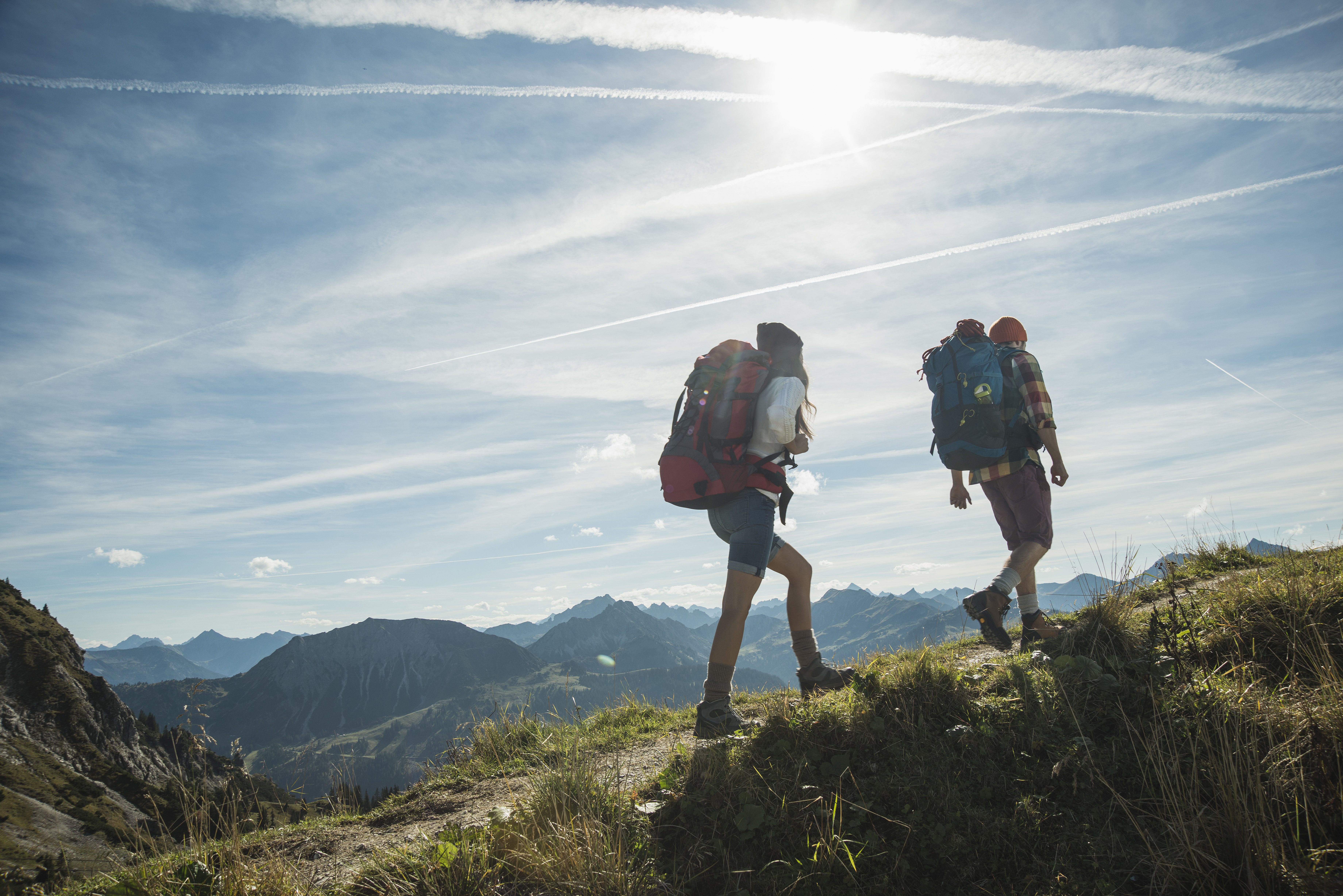 Austria, Tyrol, Tannheimer Tal, young couple hiking on mountain trail